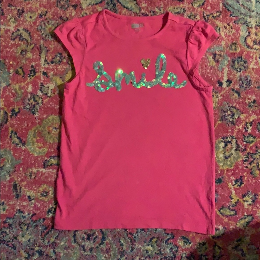 It is a cute hot pink shirt sleeved tee